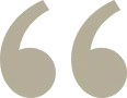 Image of a large, beige quotation mark symbol on a transparent background.