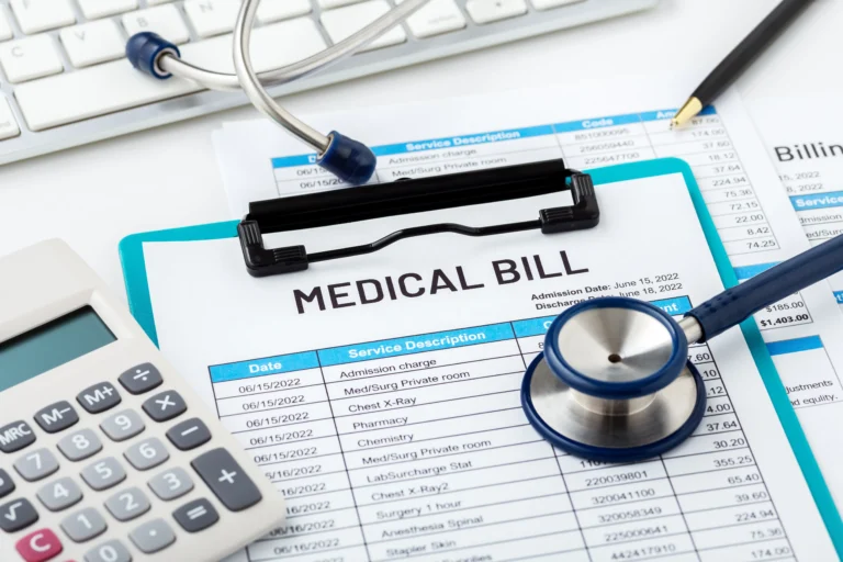Medical bill document on clipboard with stethoscope, calculator, pen, and keyboard.